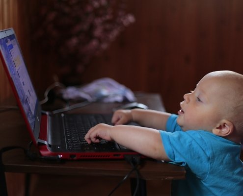 Babby playing on a laptop